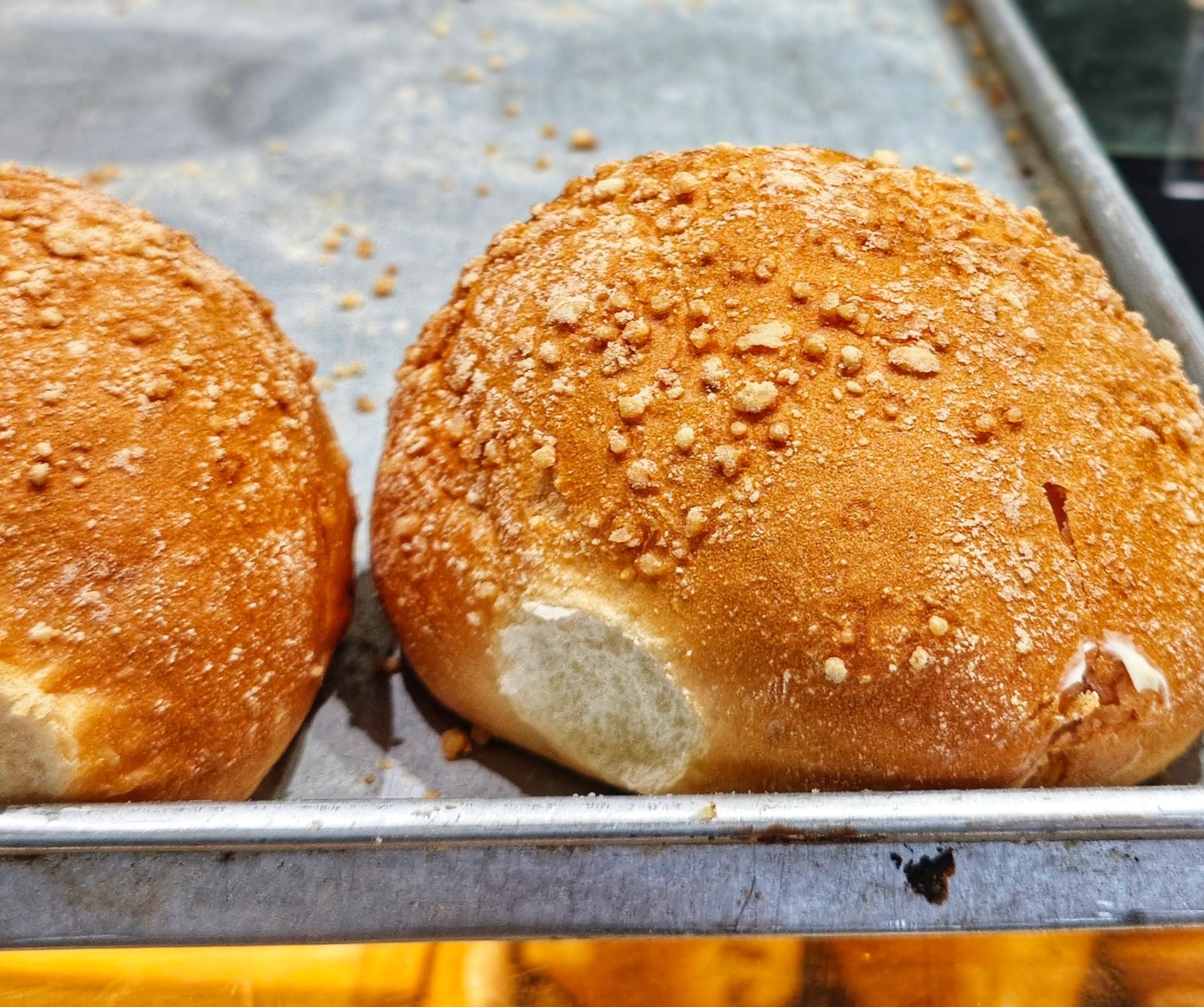 Seeded bread rolls on a baking tray