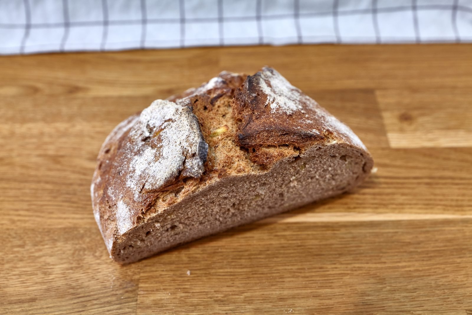 A rye loaf cut open on a wooden board