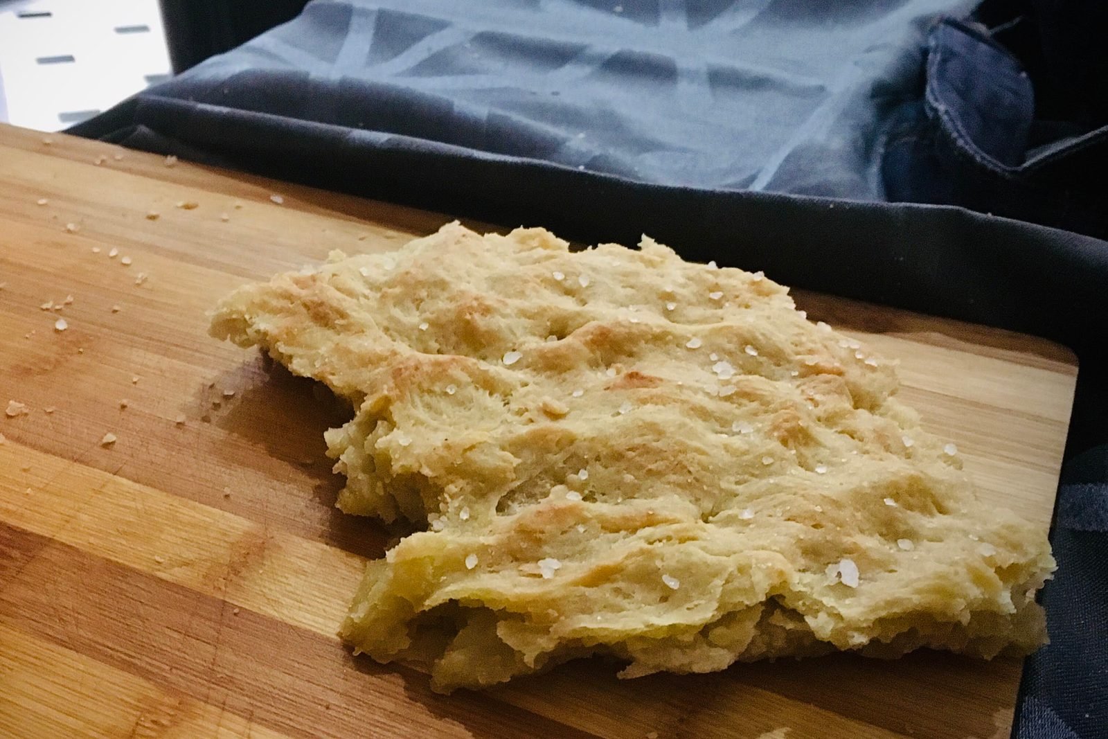 A slab of focaccia on a wooden board